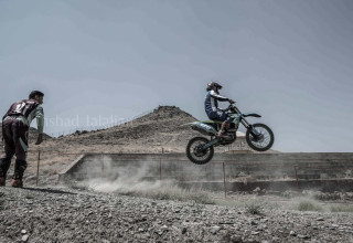 His coach is watching his race.