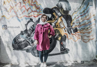 she is standing in entrance of the track.