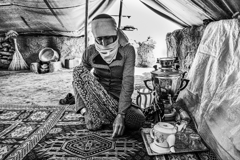 A nomad mother waits for making tea.