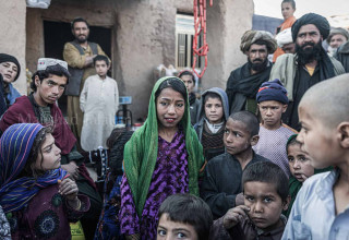 A girl standing in middle of the crowd, her father wants to 11000 Laks (Afghan currency).
